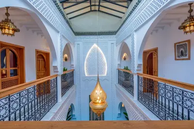 a hallway in a house with blue walls and ceilings at Riad Secret De Medina in Marrakech
