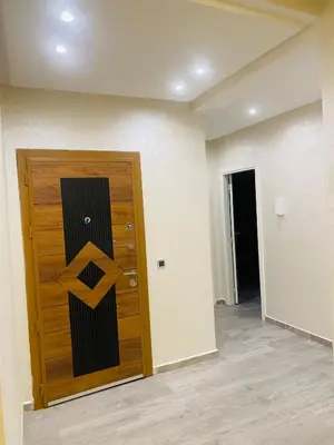 a wooden door with a sign on it in a room at Apparemment cosy pour famille in Marrakech