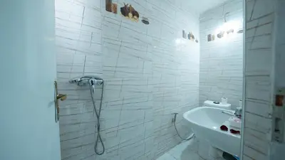 a bathroom with a shower and a toilet and a sink at Mizo House in Marrakech