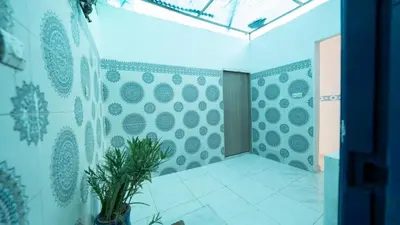 a room with blue and white walls and a plant at Mizo House in Marrakech