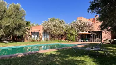 a house with a swimming pool in the yard at Villa DarJ in Marrakech