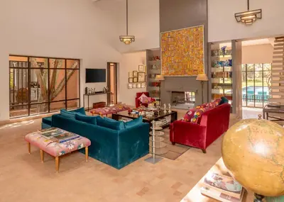 a living room with two couches and a table at Villa DarJ in Marrakech