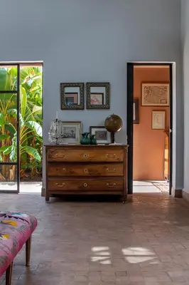 a wooden dresser in a room with a door at Villa DarJ in Marrakech