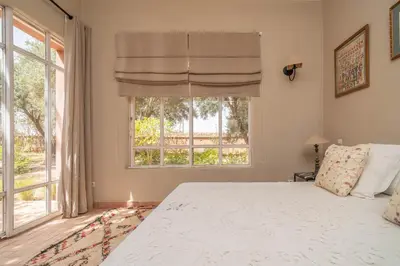 a bedroom with a bed and a large window at Villa DarJ in Marrakech