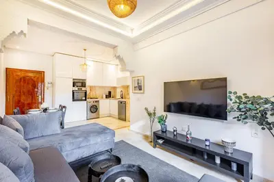 a living room with a couch and a flat screen tv at Luxe et calme en plein centre de Marrakech in Marrakech