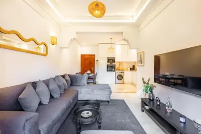 a living room with a couch and a table at Luxe et calme en plein centre de Marrakech in Marrakech
