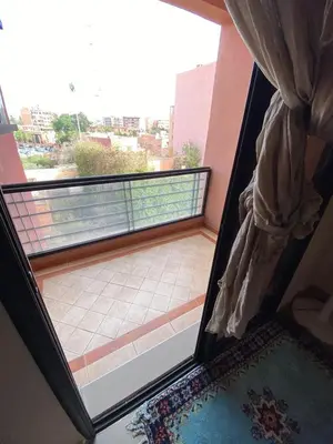 a room with a balcony with a window and a view at اقامة كنزي مراكش كليز in Marrakech