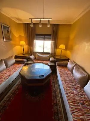 a living room with a couch and a coffee table at اقامة كنزي مراكش كليز in Marrakech
