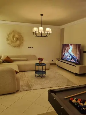 a living room with a couch and a flat screen tv at La Boheme City Center Entire Unique Appart 3Bdr 3Bthr in Marrakech