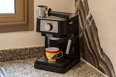a coffee maker sitting on a counter with a coffee cup at Sunny Getaway with Pool Access & Private Yard in Marrakech