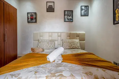 a bedroom with a large bed with towels on it at Sunny Getaway with Pool Access & Private Yard in Marrakech