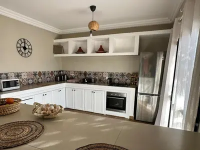 a kitchen with white cabinets and a counter top at Villa Léa 2 Marrakech in Marrakech