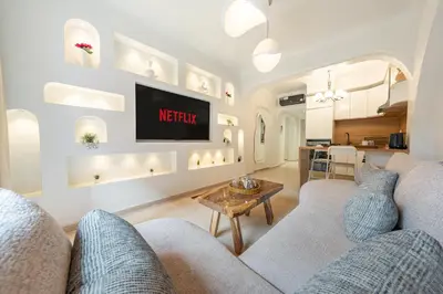 a living room with a couch and a tv at White Oasis Swimming pool and Design in Marrakech