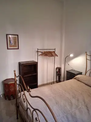 a bedroom with a bed and a dresser at Casa Rosa in Marrakech