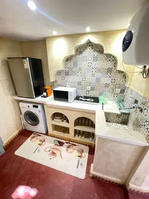 a kitchen with a washer and dryer in a room at Riad Elegant suite in the heart of the Medina in Marrakech