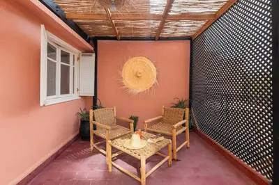 a patio with a table and chairs and a window at Modern studio with terrace in Marrakech