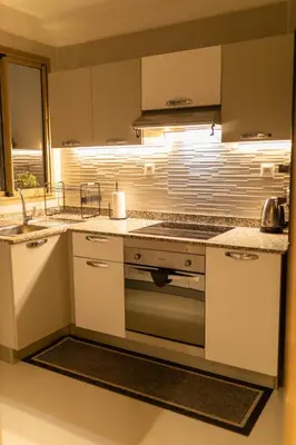 a kitchen with a stove and a counter top at Casaterra Luxury apartment with pool & home-cinema in Marrakech