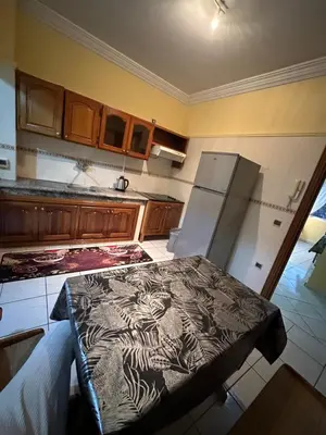 a kitchen with a table and a refrigerator at Appartement, centre-ville, Marrakech, Gueliz in Marrakech