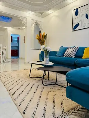 a living room with a blue couch and a table at the sweet night of Marrakech in Marrakech