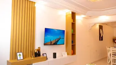 a living room with a flat screen tv on a wall at the sweet night of Marrakech in Marrakech