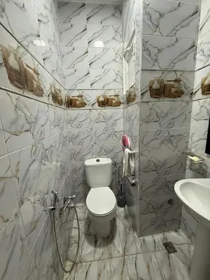 a bathroom with a toilet and a sink at Location longue durée in Marrakech