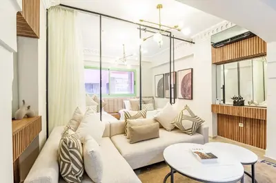 a living room with a couch and a table at Suite Moderne Deluxe Miracle, à Babylone, Hyper-Centre, Marrakesh in Marrakech