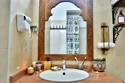 a bathroom with a sink and a mirror at Dar Kech Luxury et comfort in Marrakech