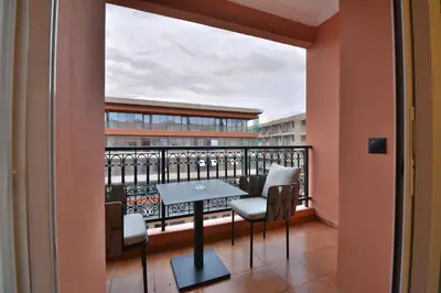a balcony with a table and chairs at L'adresse- Appartement 4p au centre de Marrakech in Marrakech
