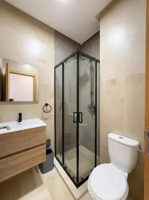 a bathroom with a shower and a toilet and a sink at Modern, Luxurious, Pool View, 3 Terraces, Golf in Marrakech