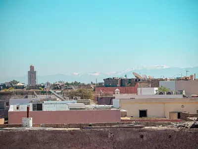a view of a city with mountains in the background at Riad Louzaia, Marrakech in Marrakech