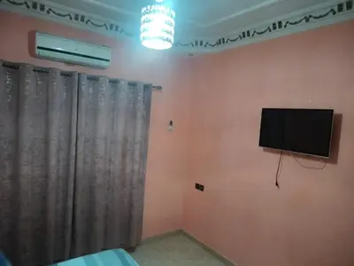 a living room with a flat screen tv on the wall at house mohamed in Marrakech