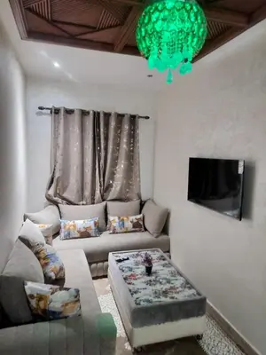 a living room with a couch and a flat screen tv at house mohamed in Marrakech