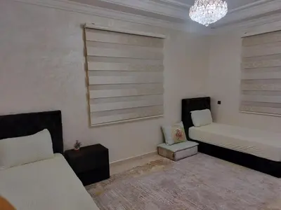 a living room with two beds and a couch at house mohamed in Marrakech