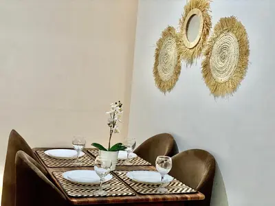 a table with plates and wine glasses on it at Appartement 2 chambres à Gueliz avec piscine Emplacement parfait in Marrakech