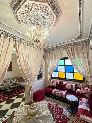 a living room with a chandelier and a couch at flat in Marrakech in Marrakech