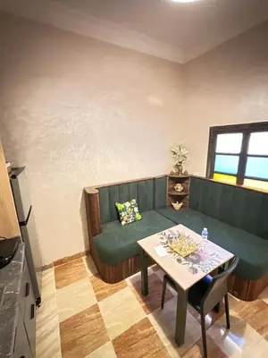 a living room with a green couch and a table at flat in Marrakech in Marrakech