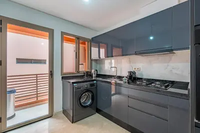 a kitchen with a washer and a washing machine at Gueliz apartment with pool, spa and gym in Marrakech