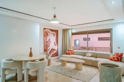 a living room with a couch and a table at Gueliz apartment with pool, spa and gym in Marrakech
