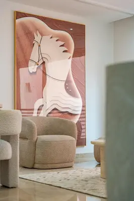 a living room with a painting of a horse on the wall at Gueliz apartment with pool, spa and gym in Marrakech