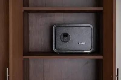 a small tv sitting on a wooden shelf at Gueliz apartment with pool, spa and gym in Marrakech