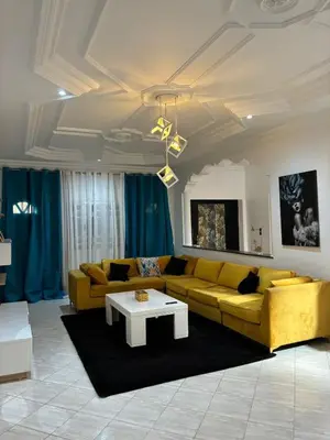 a living room with a yellow couch and a coffee table at the wonder of Marrakesh in Marrakech