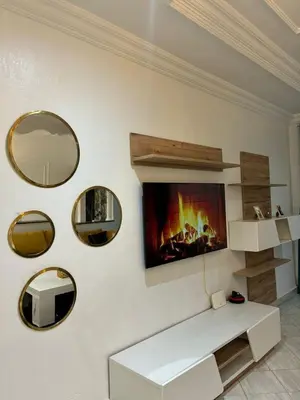 a living room with a fireplace and mirrors on the wall at the wonder of Marrakesh in Marrakech