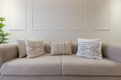 a couch with four pillows on it in a living room at palace studio gueliz et proche gare central in Marrakech