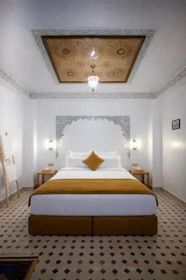 a bedroom with a large bed in a room at Riad el fassi & spa charme authentique piscine chauffée in Marrakech