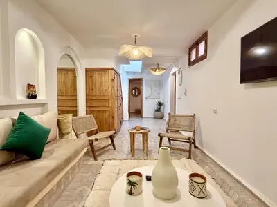 a living room with a couch and a table at Kasbahbibi pool breakfast city center private in Marrakech