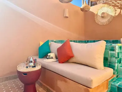 a bench in a room with colorful pillows on it at Kasbahbibi pool breakfast city center private in Marrakech