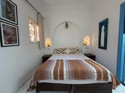 a bedroom with a bed in a white room at Calm & Authentic in Marrakesh in Marrakech