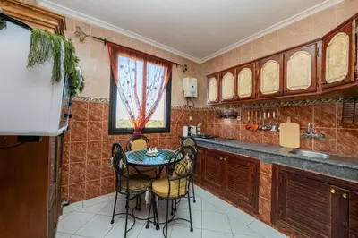 a kitchen with a table and chairs in it at DarSaouiri55 in Marrakech