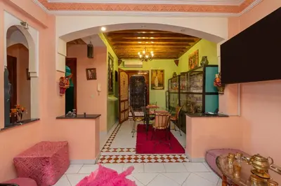 a living room with pink and green walls at DarSaouiri55 in Marrakech