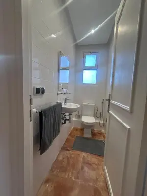 a white bathroom with a sink and a toilet at Appartement 3 Chambres 140 m Najd, Calme & Confort in Marrakech